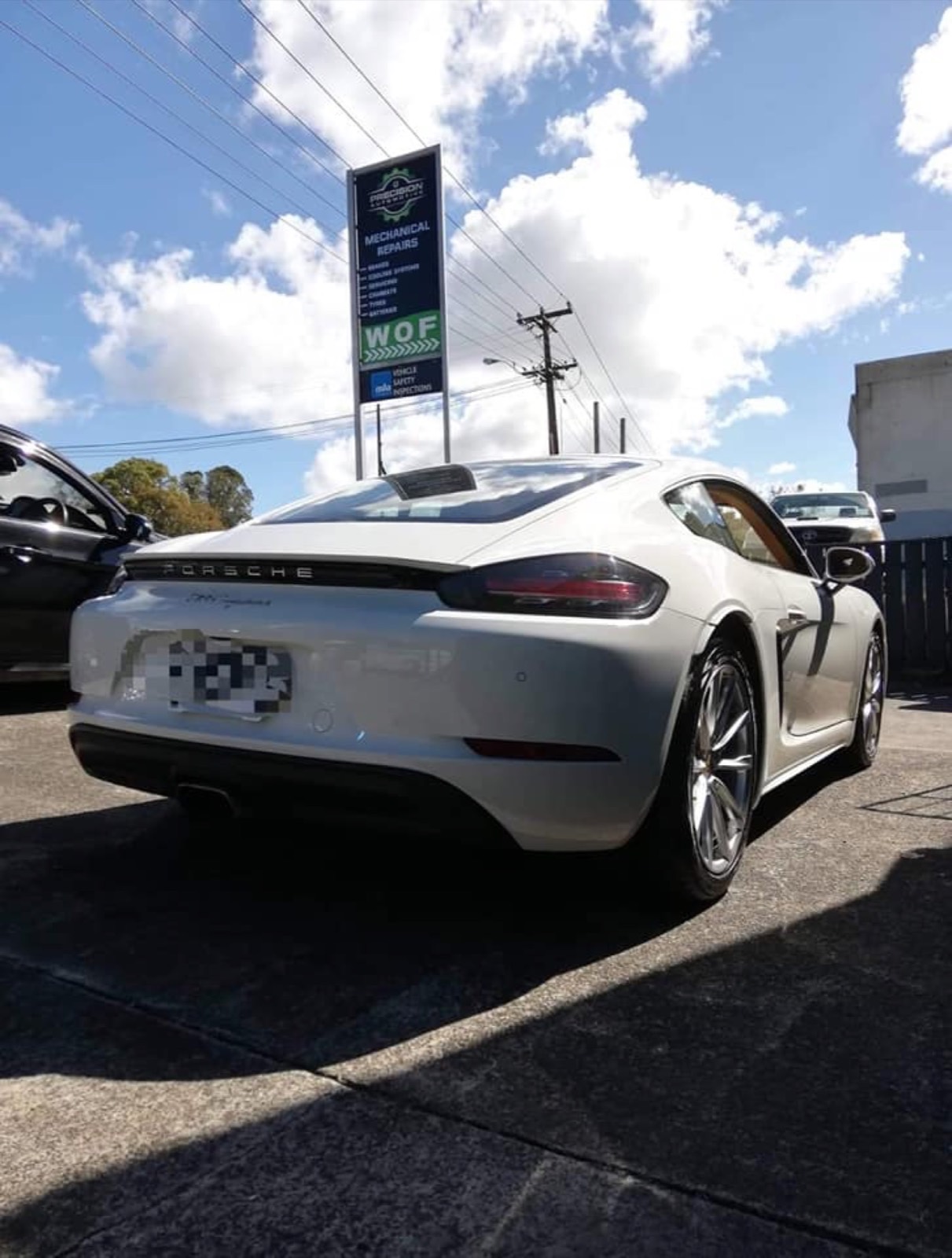 Porsche 718 outside Precision Automotive — wheel alignment work