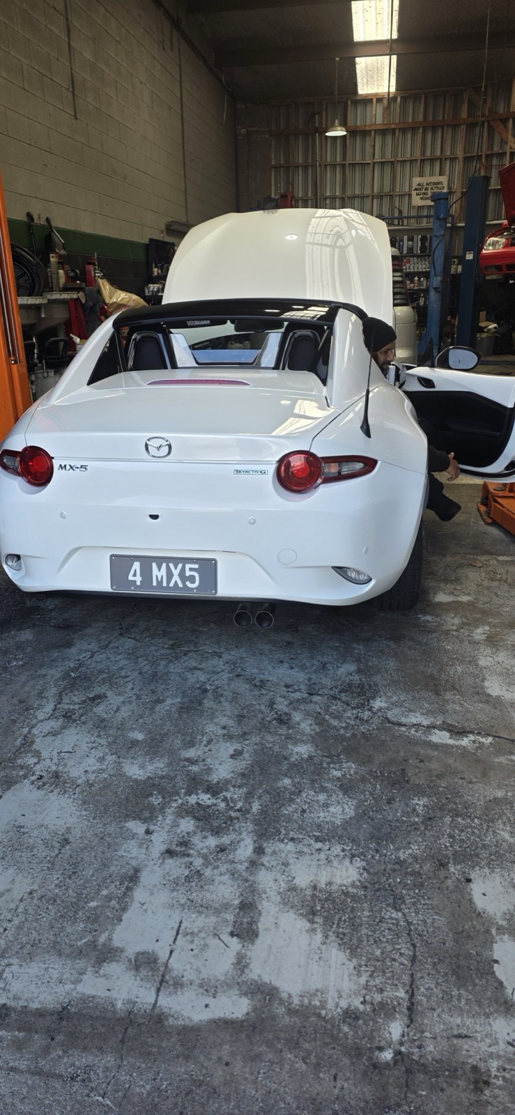 Mazda MX-5 on a hoist mid-service at Precision Automotive